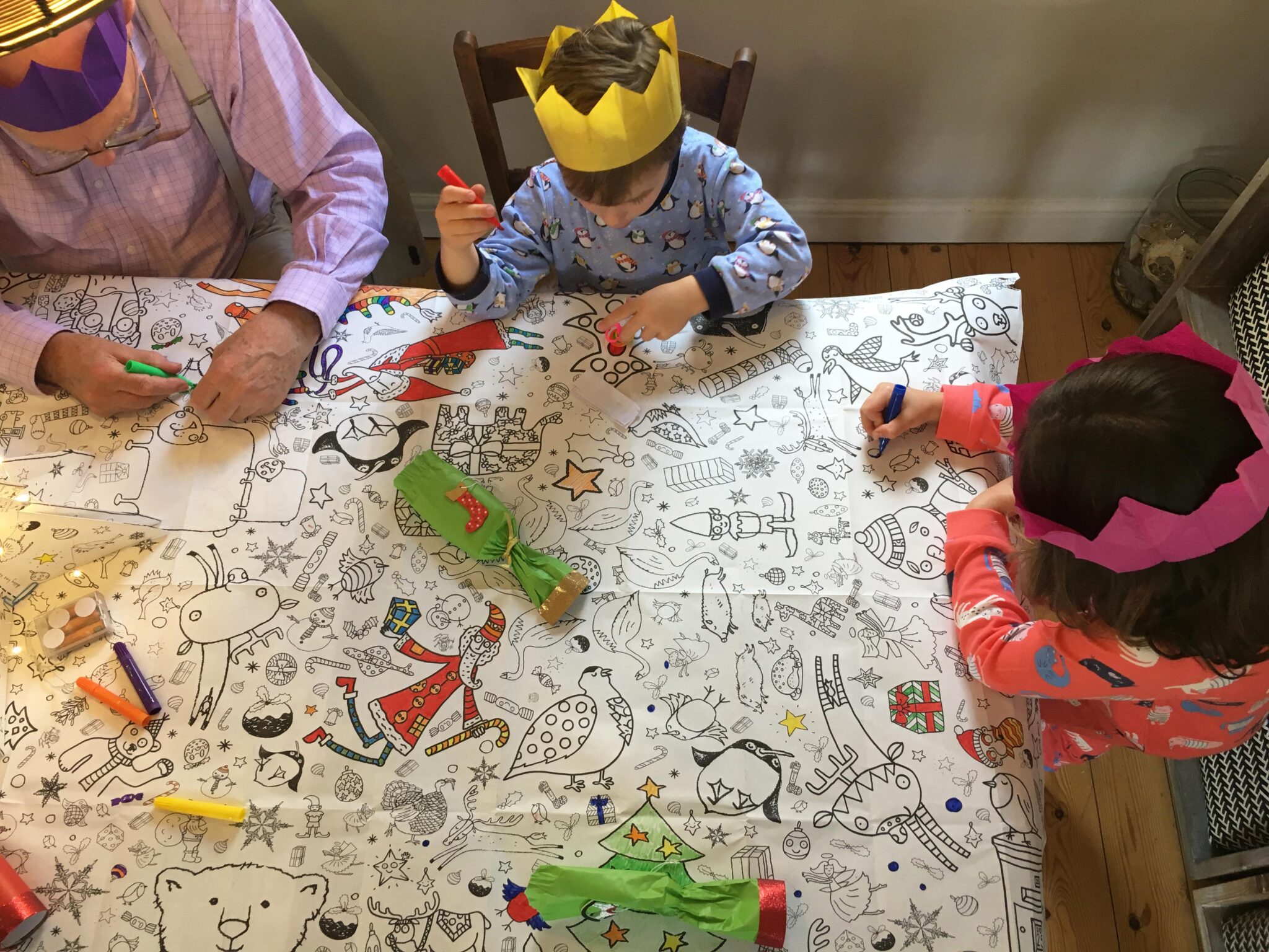 Christmas 2018 family colouring in a paper table cloth