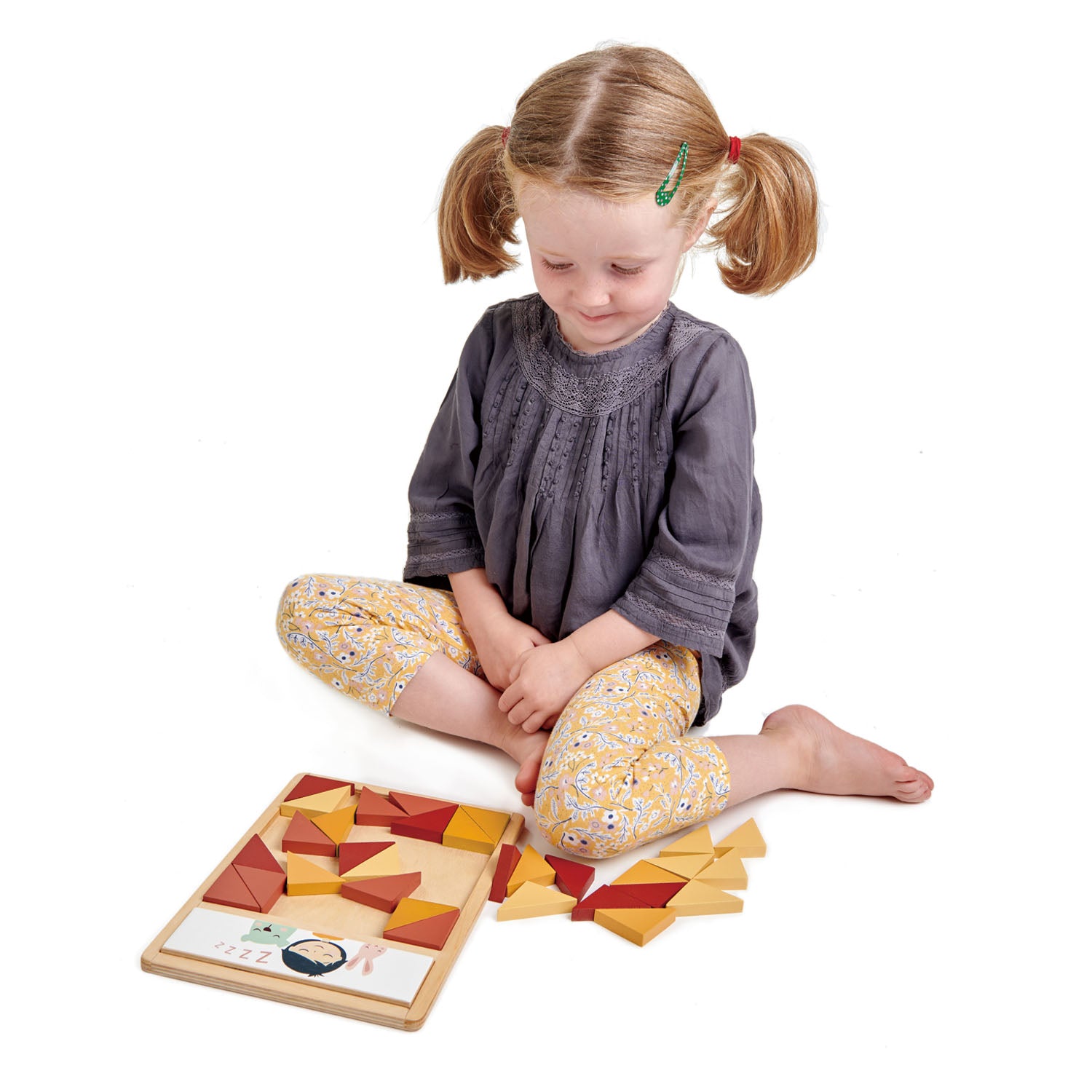 Girl playing with wooden puzzle