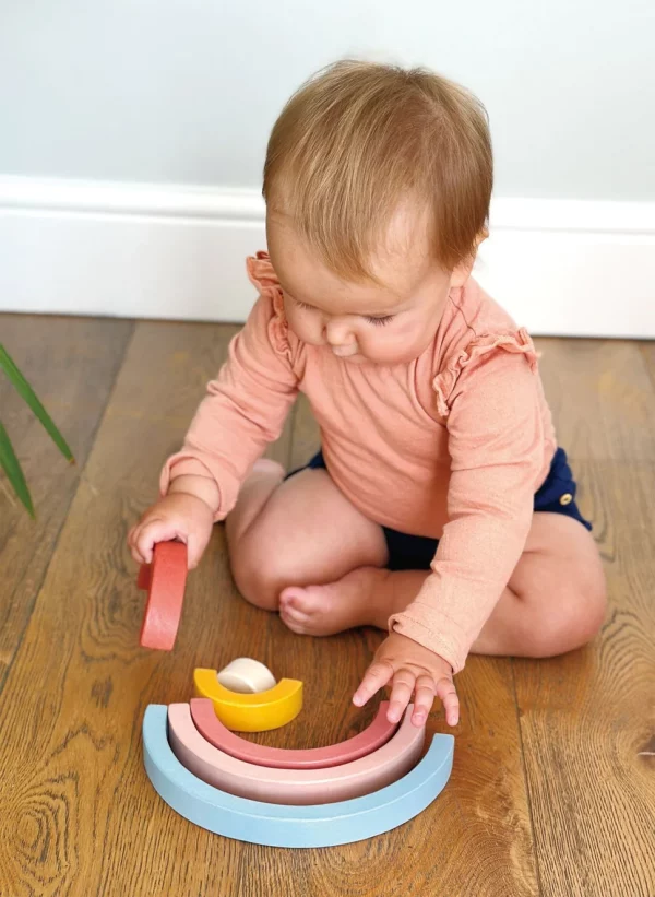 baby playing with wooden stacking toy
