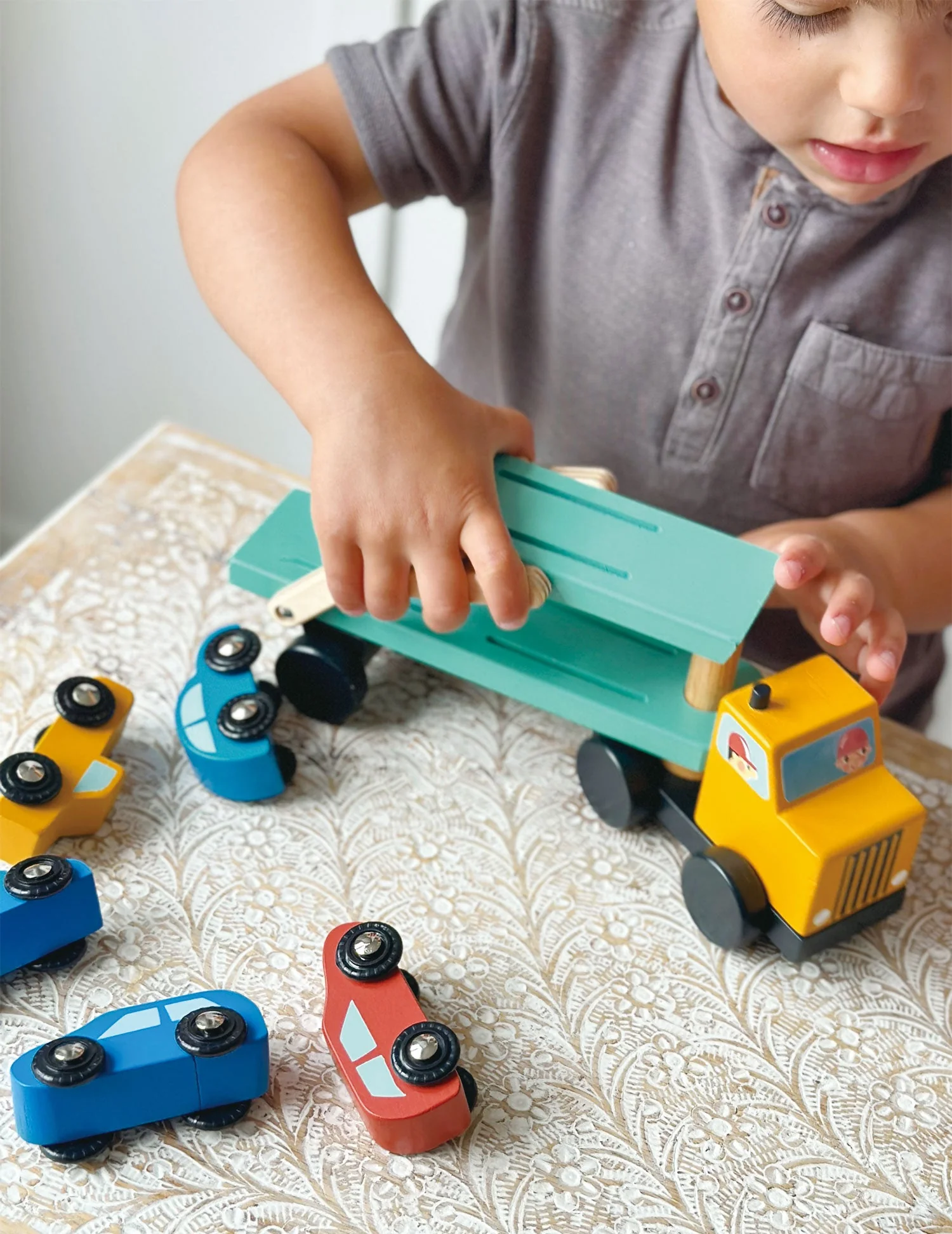 boy play with car transporter