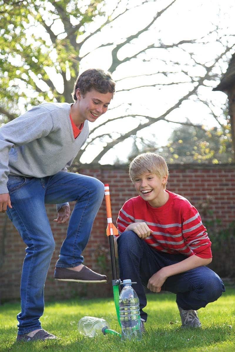 boys playing with green rocket